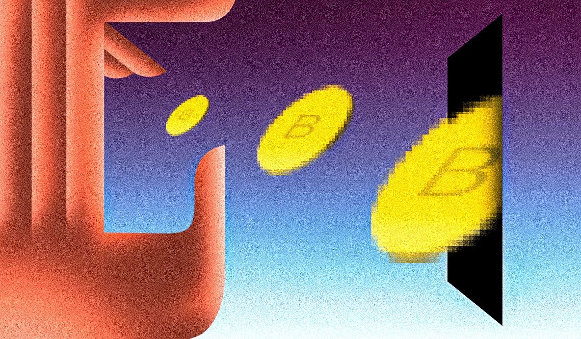 A hand dropping bitcoin tokens into a slot A hand dropping bitcoin tokens into a slot